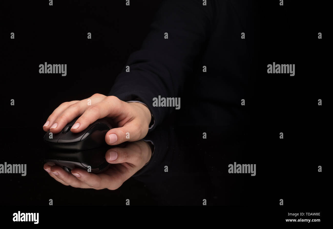 Small Hand Using Mouse Hand using wireless mouse in a dark environment Stock Photo - Alamy