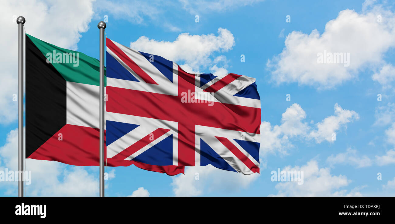 Kuwait and United Kingdom flag waving in the wind against white cloudy blue sky together. Diplomacy concept, international relations. Stock Photo