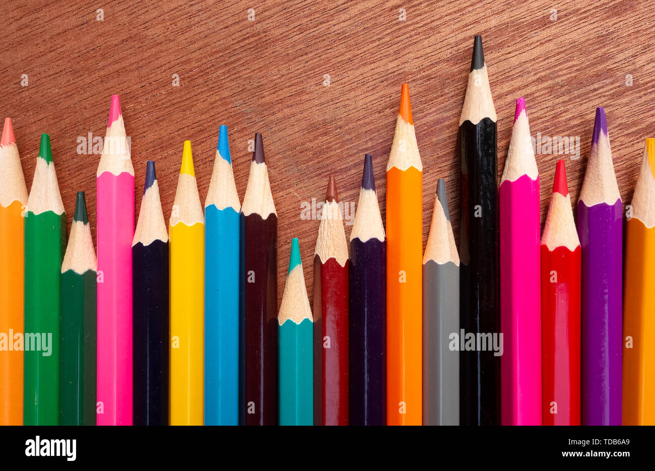 Kids drawing of family and colored pencils on wooden table Stock Photo -  Alamy