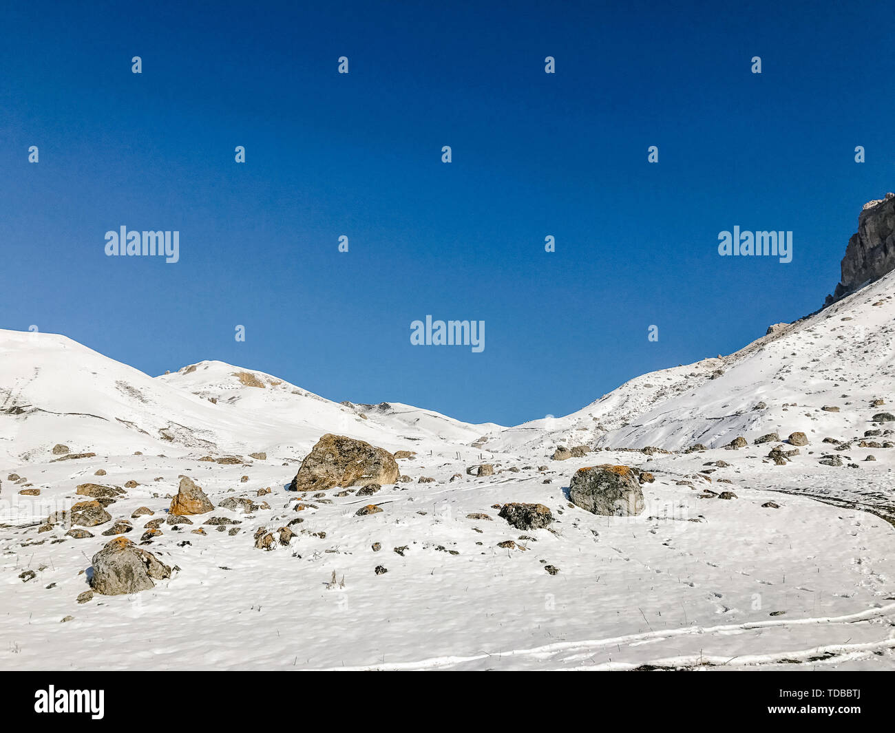 landscape of mountains and hills covered with snow against the sky Stock Photo