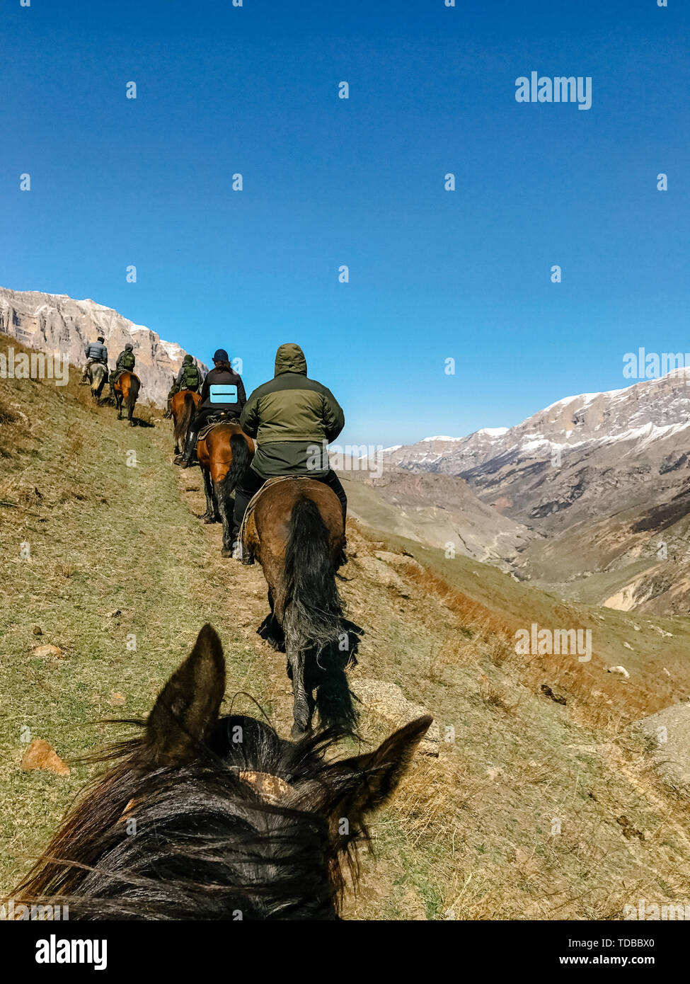 horseback view from the first person opens a review of the riders in the mountains Stock Photo