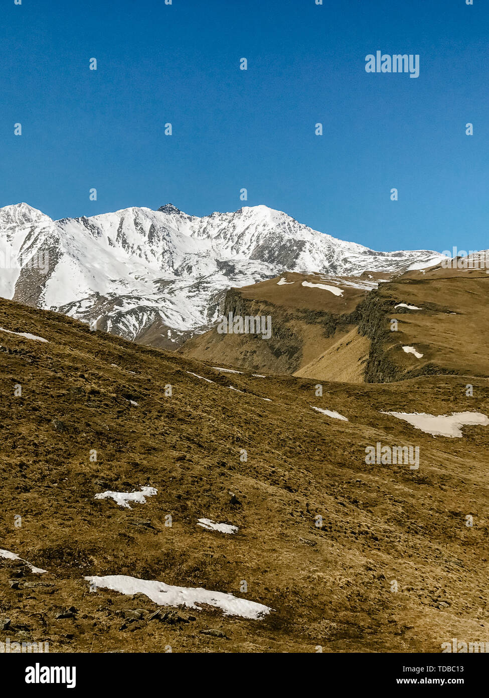 landscape of mountains and hills covered with snow against the sky Stock Photo