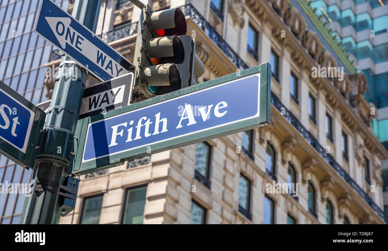 Fifth ave street sign, Manhattan New York downtown. Blue sign on blur ...