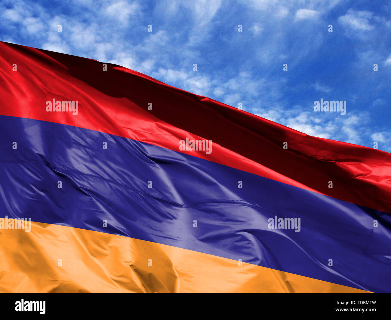 waving flag of Armenia close up against blue sky Stock Photo - Alamy