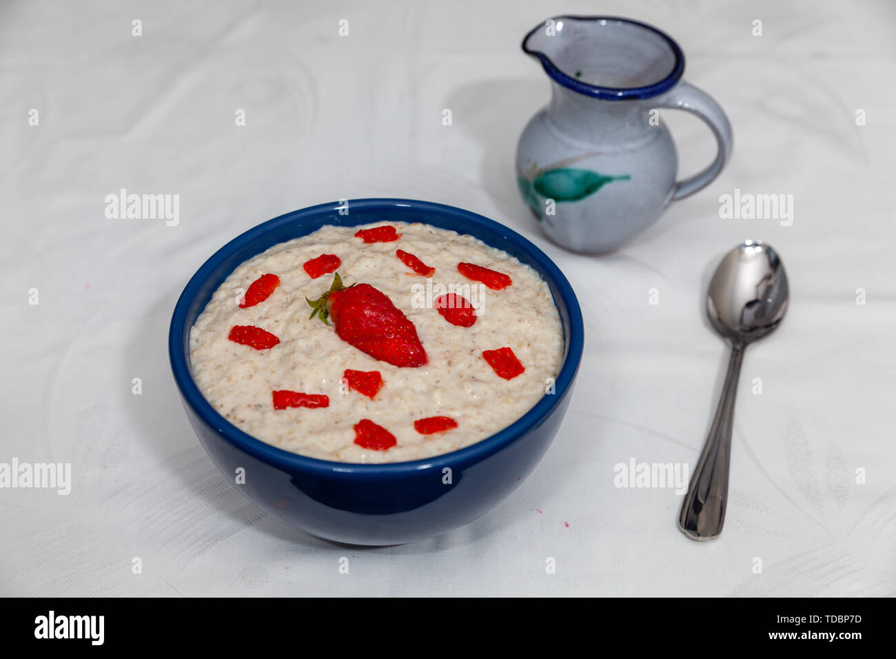 A plain bowl of Porridge, also with Strawberry and cream Stock Photo ...