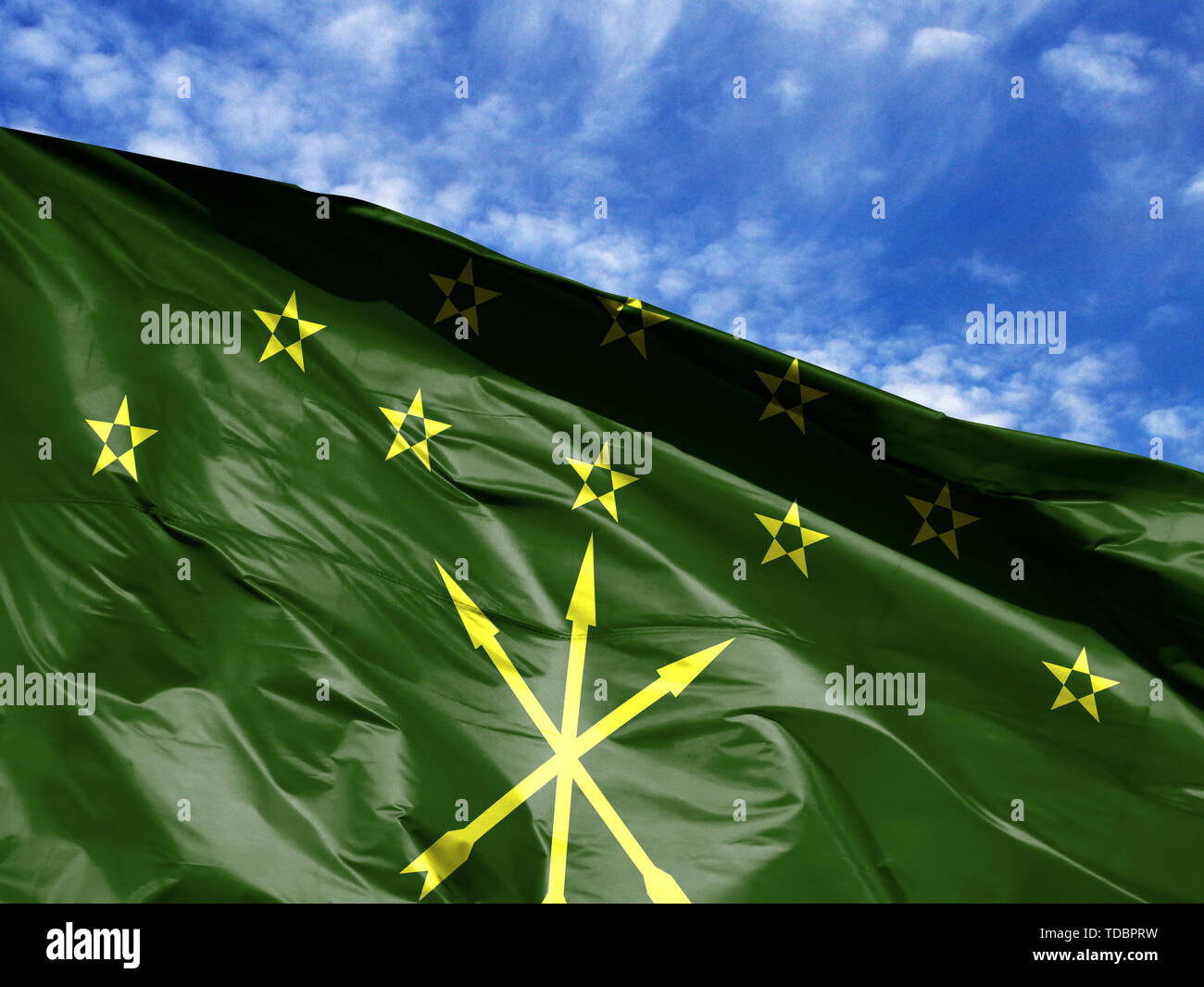 waving flag of Adygea close up against blue sky Stock Photo