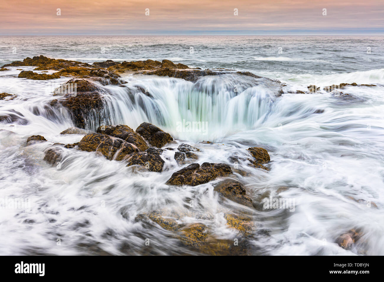 Thor's Well is a part of Cape Perpetua (a forested headland  that extends out into the Pacific Ocean) a part of Oregon's coast. Stock Photo