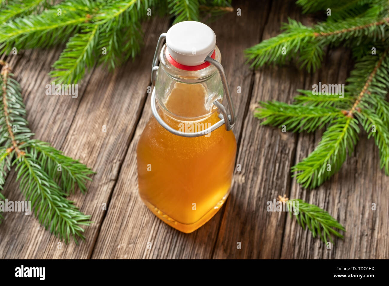 A bottle of homemade syrup against cough made from young spruce tips Stock Photo