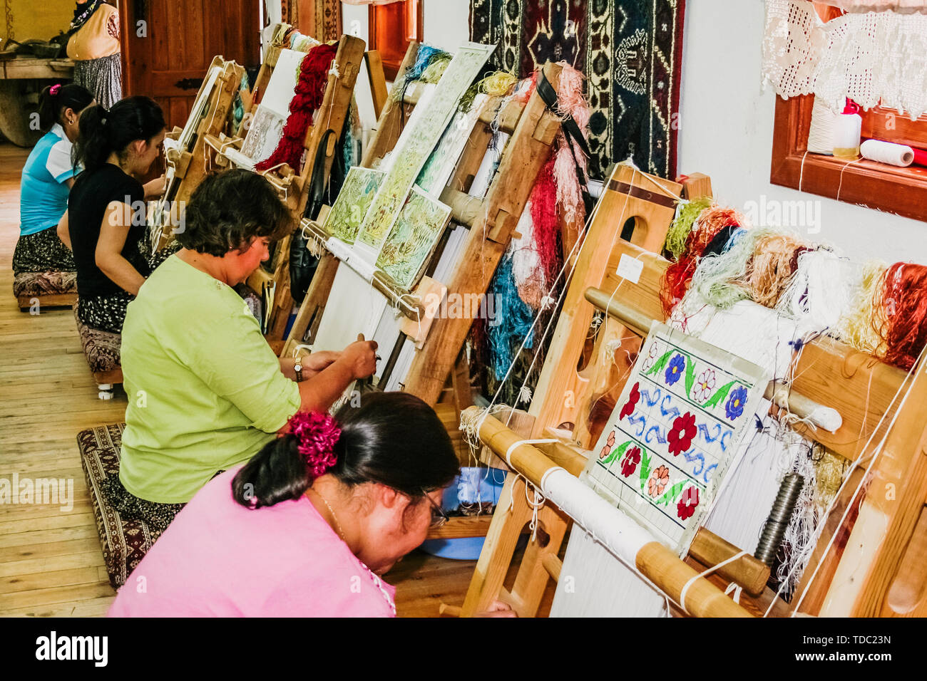 Turkish Woman Making Rug Goreme, Turkey - June 14, 2019: Artisan women weaving Turkish rugs on ...