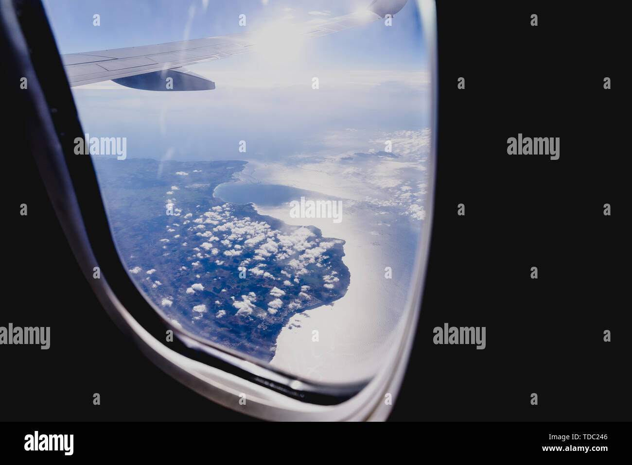 Clouds and sky seen through the window of an airplane, airplane travel ...