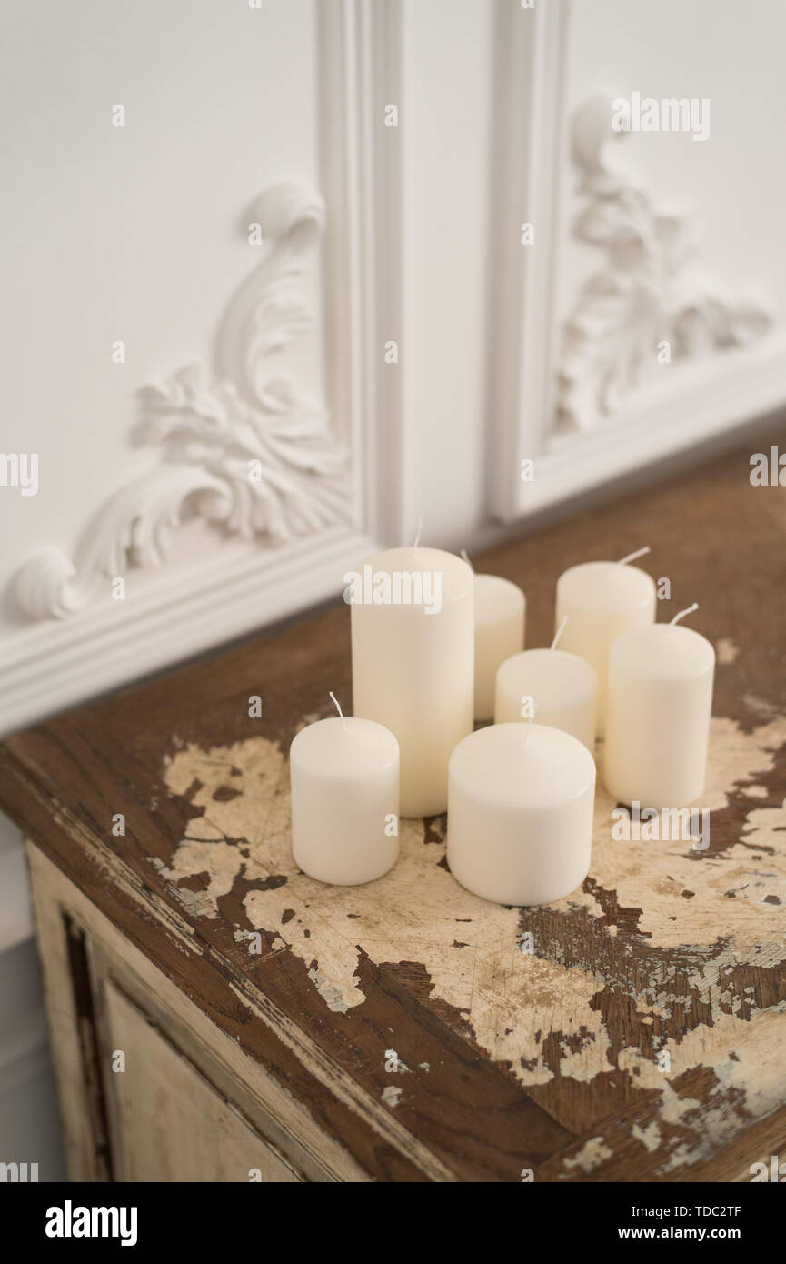Vintage chest of drawers decorated with candles. Close up. Selective focus. Stock Photo