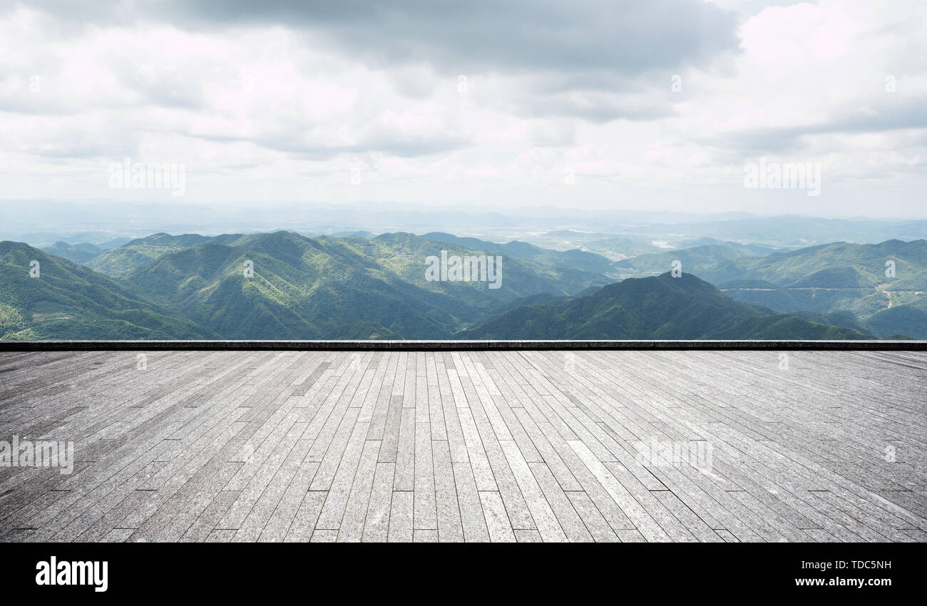 Empty brick floor with green hills Stock Photo