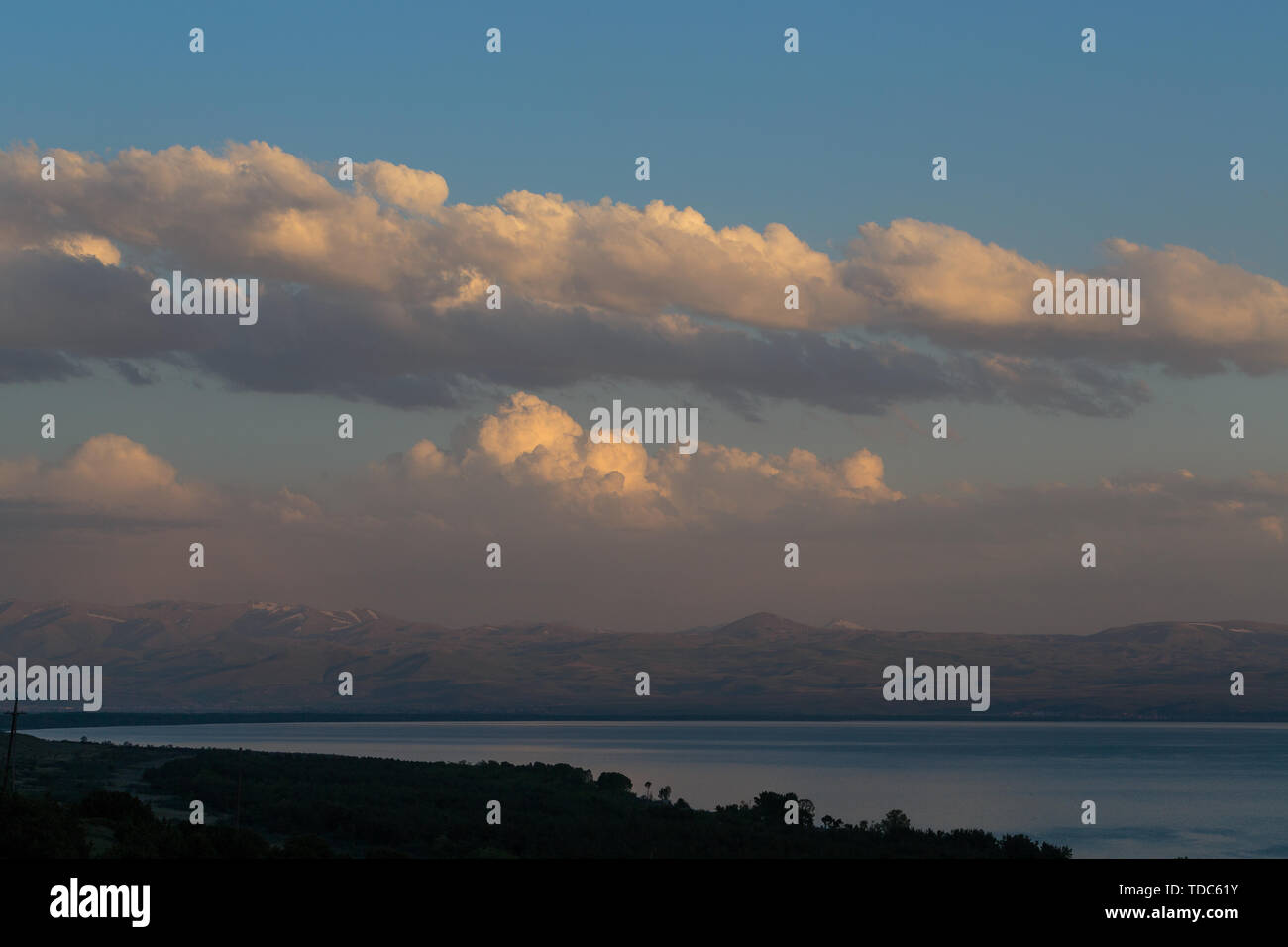 evening landscape of the sea against the backdrop of mountains and clouds Stock Photo