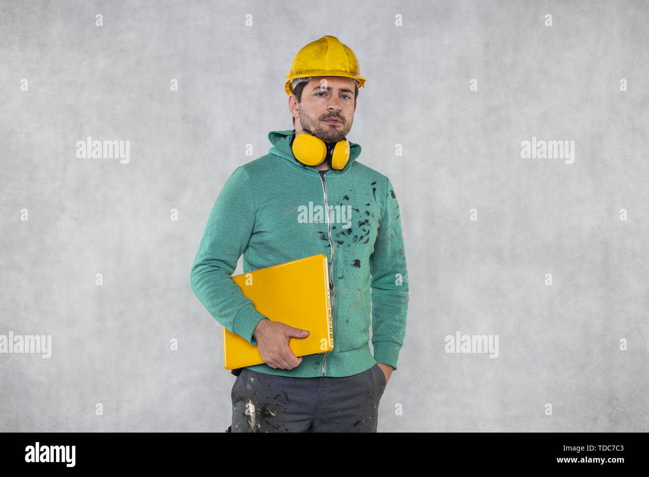 modern building supervisor keeps the computer in his hands, technology at work Stock Photo