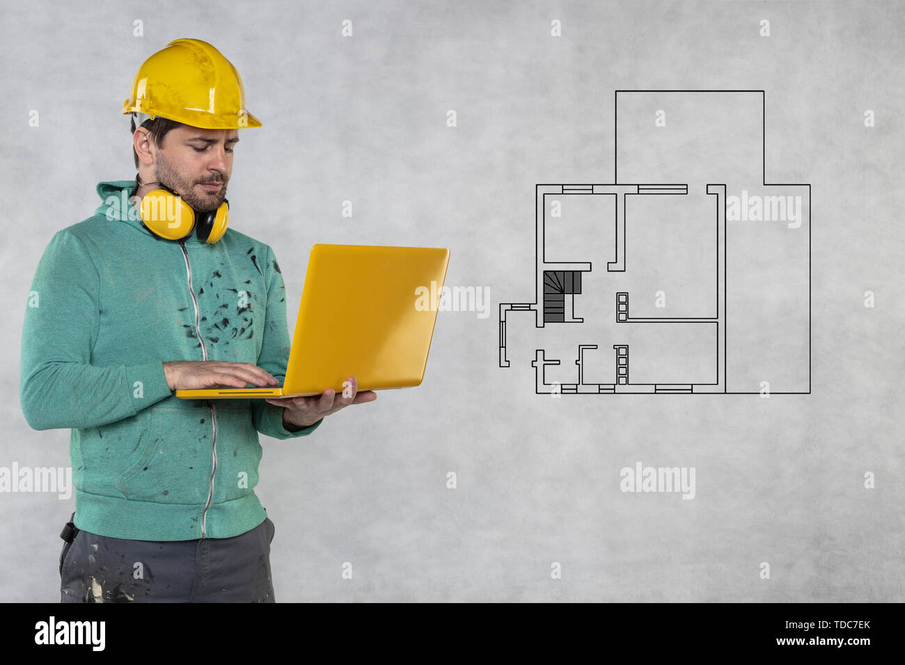 modern building supervisor keeps the computer in his hands, technology at work Stock Photo