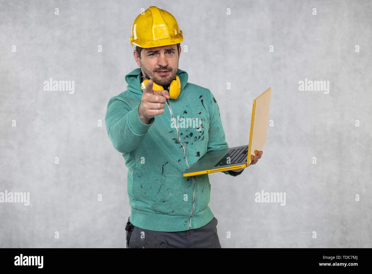 modern building supervisor keeps the computer in his hands, technology at work Stock Photo