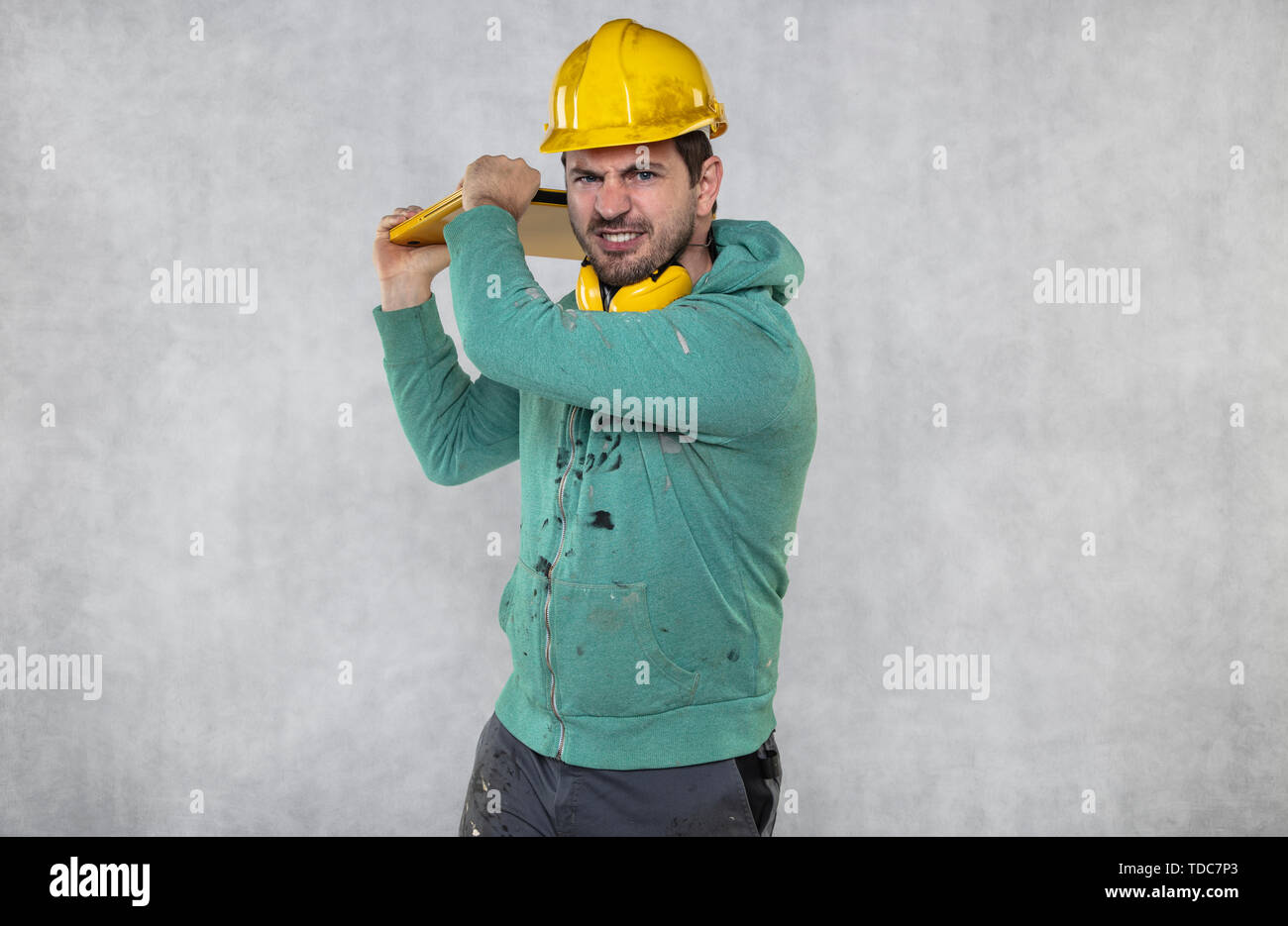 modern building supervisor keeps the computer in his hands, technology at work Stock Photo