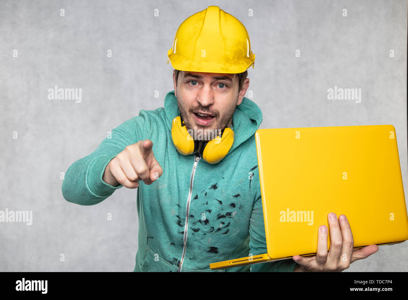 modern building supervisor keeps the computer in his hands, technology at work Stock Photo