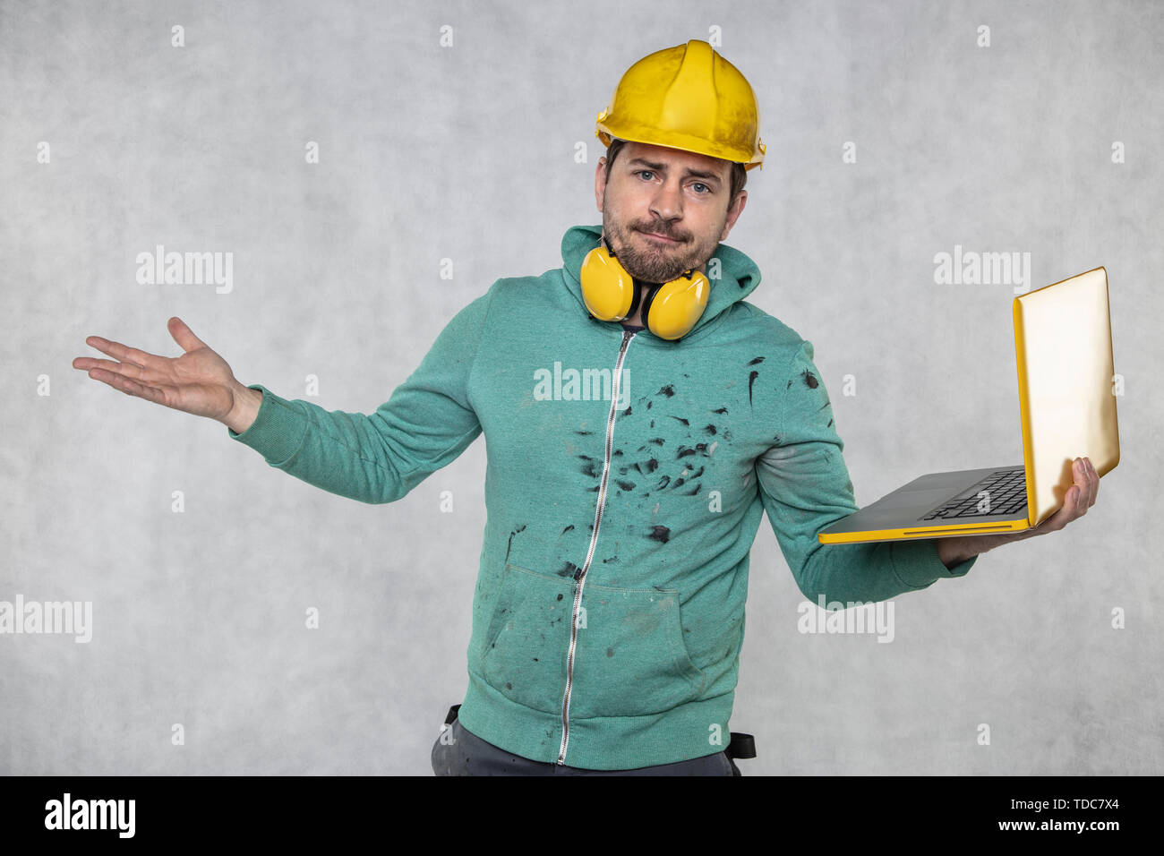 modern building supervisor keeps the computer in his hands, technology at work Stock Photo