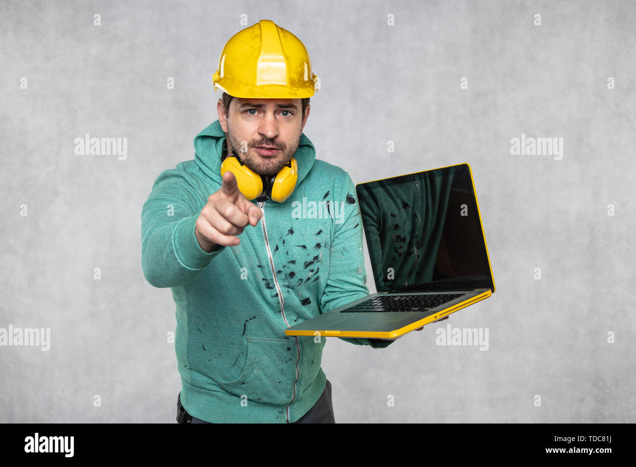 modern building supervisor keeps the computer in his hands, technology at work Stock Photo
