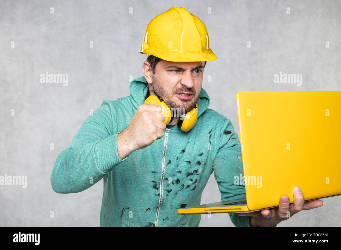 modern building supervisor keeps the computer in his hands, technology at work Stock Photo