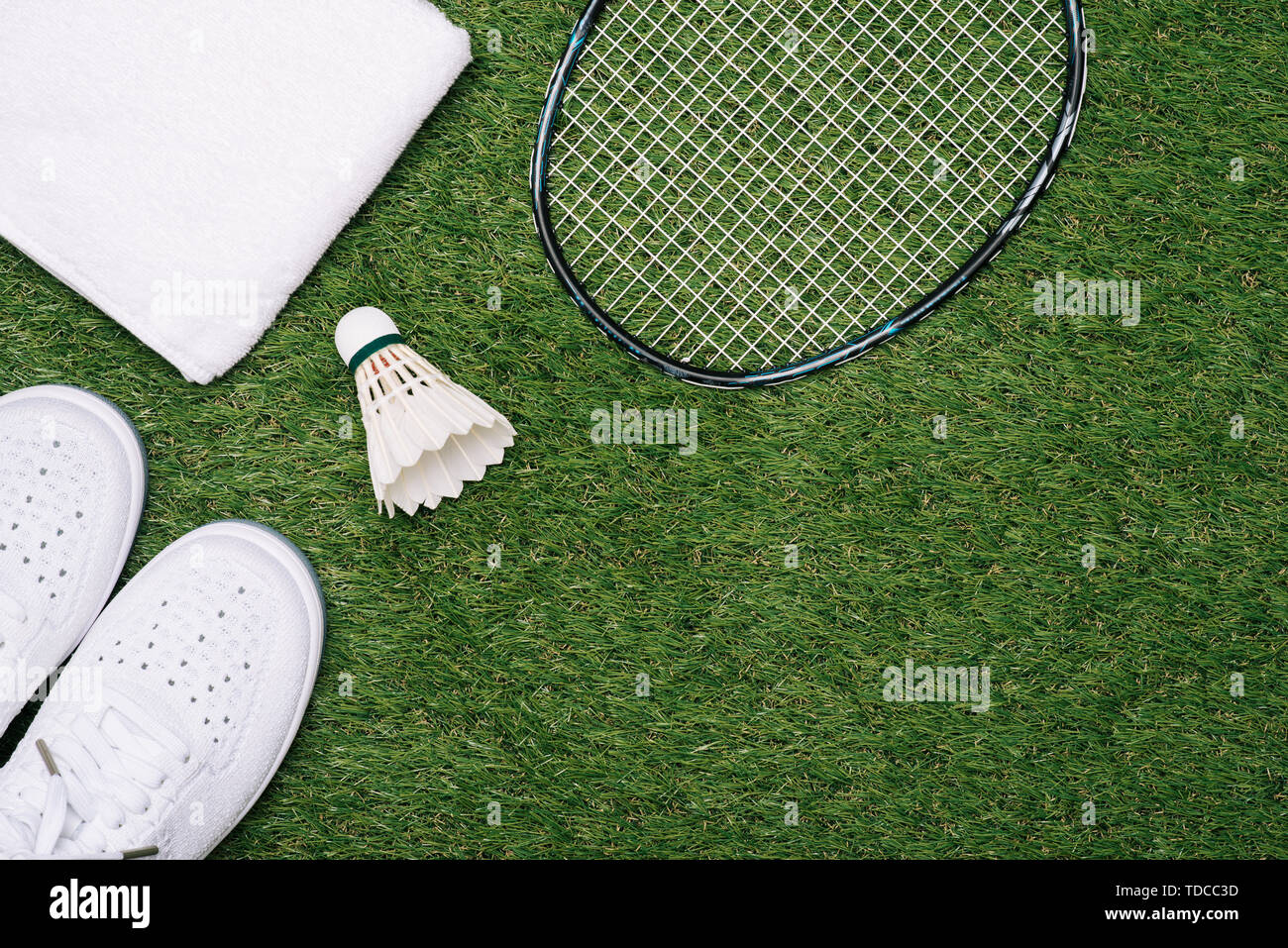 sports set of blue sport shoes and shuttlecocks with badminton racket on grass background in concept family activity Stock Photo