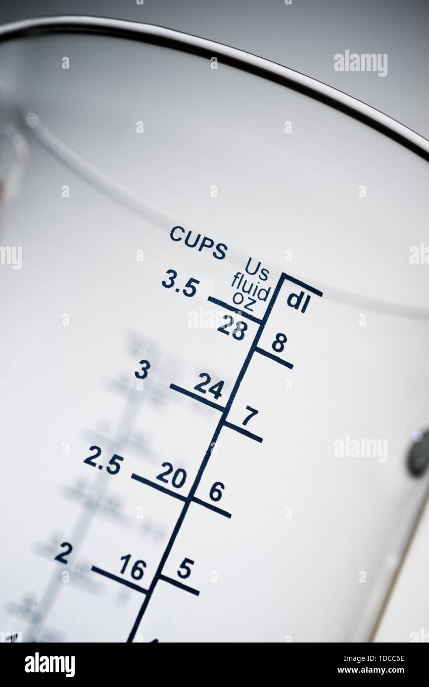 Graduated glass jug to measure ingredients cooking. Stock Photo