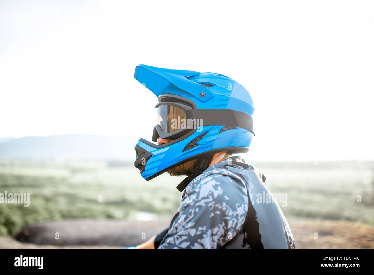 Portrait of a wellequipped rider wearing fullface helmet outdoors