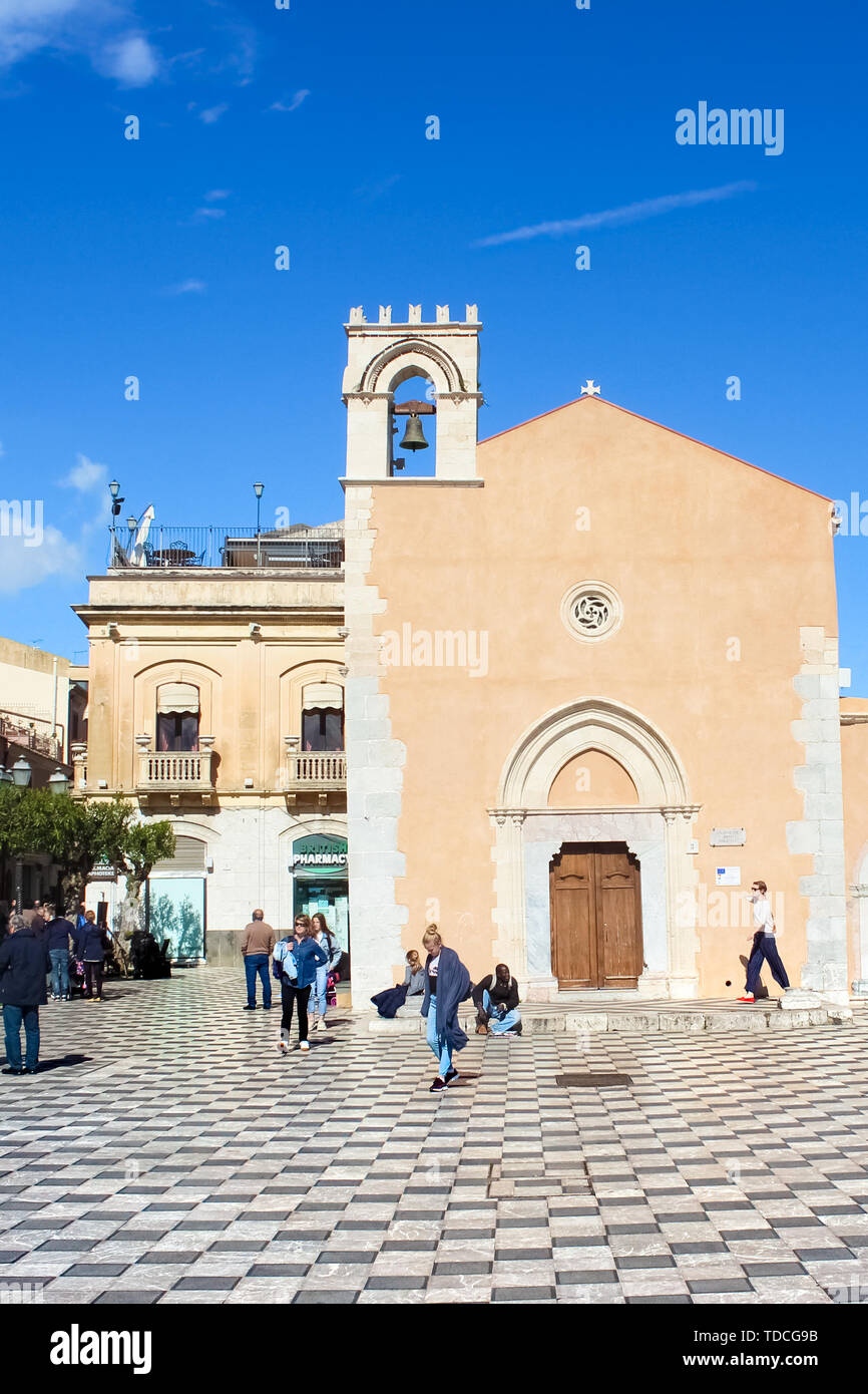Taormina, Sicily, Italy - Apr 8th 2019: People on the Piazza IX Aprile Square in beautiful historical center of the Italian city. Famous tourist spot. Travel destination, sightseeing. Stock Photo