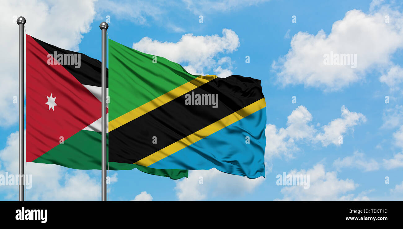 Jordan and Tanzania flag waving in the wind against white cloudy blue sky together. Diplomacy concept, international relations. Stock Photo