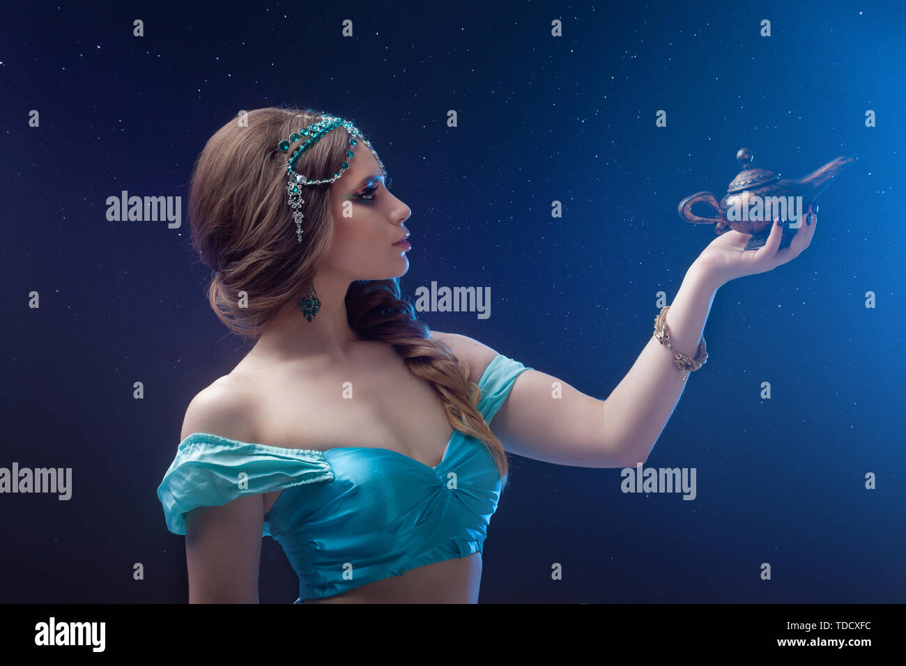 Arab night, make a wish at gene's. Fabulous heroine Jasmine with a magic lamp. Dark night background Stock Photo