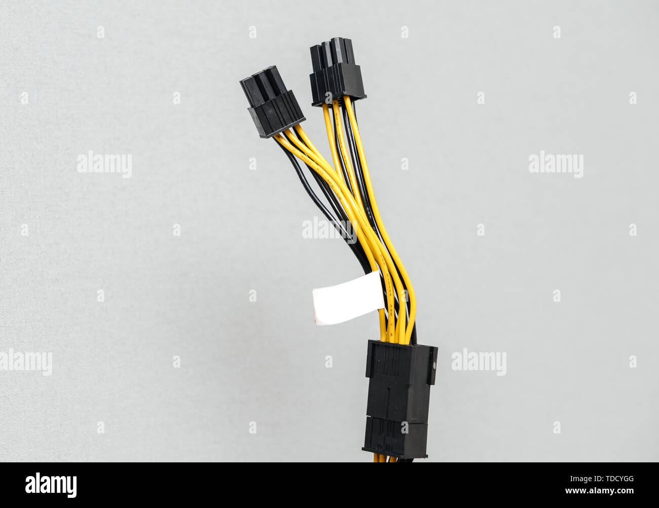 Detail of new power adapter cable dongle splitter against gray