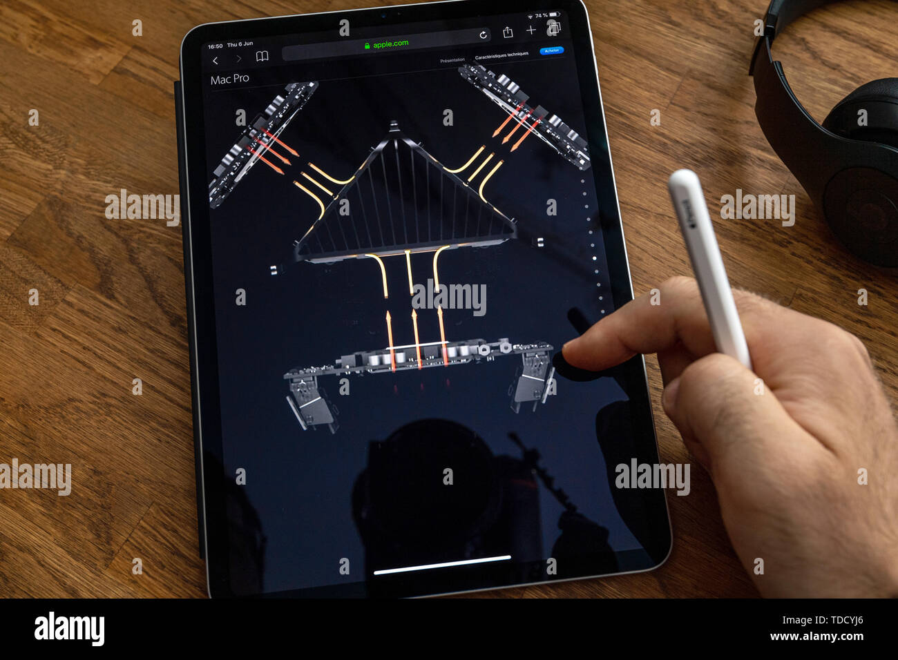 Paris, France Jun 6, 2019 Man reading on Apple iPad Pro tablet about powerful professional