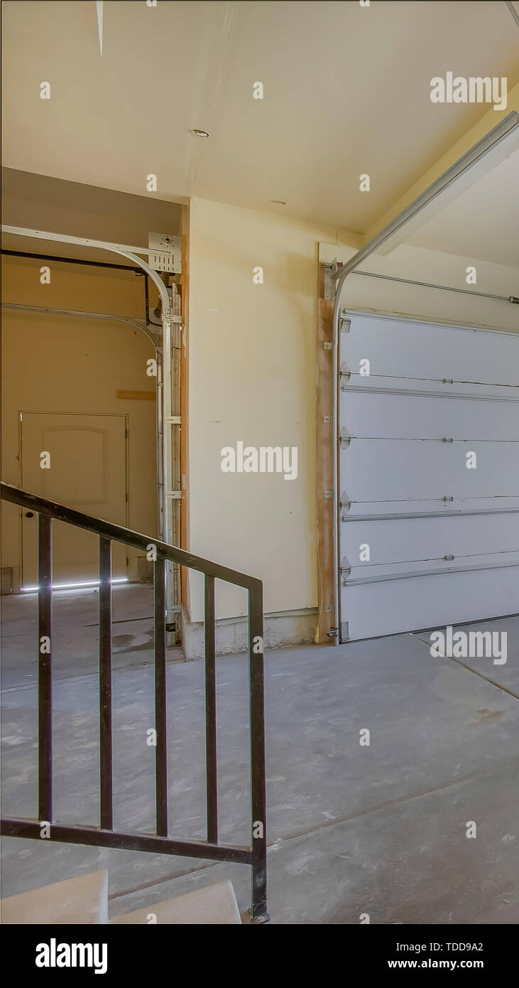 Vertical Empty garage with white doors as well as arched and