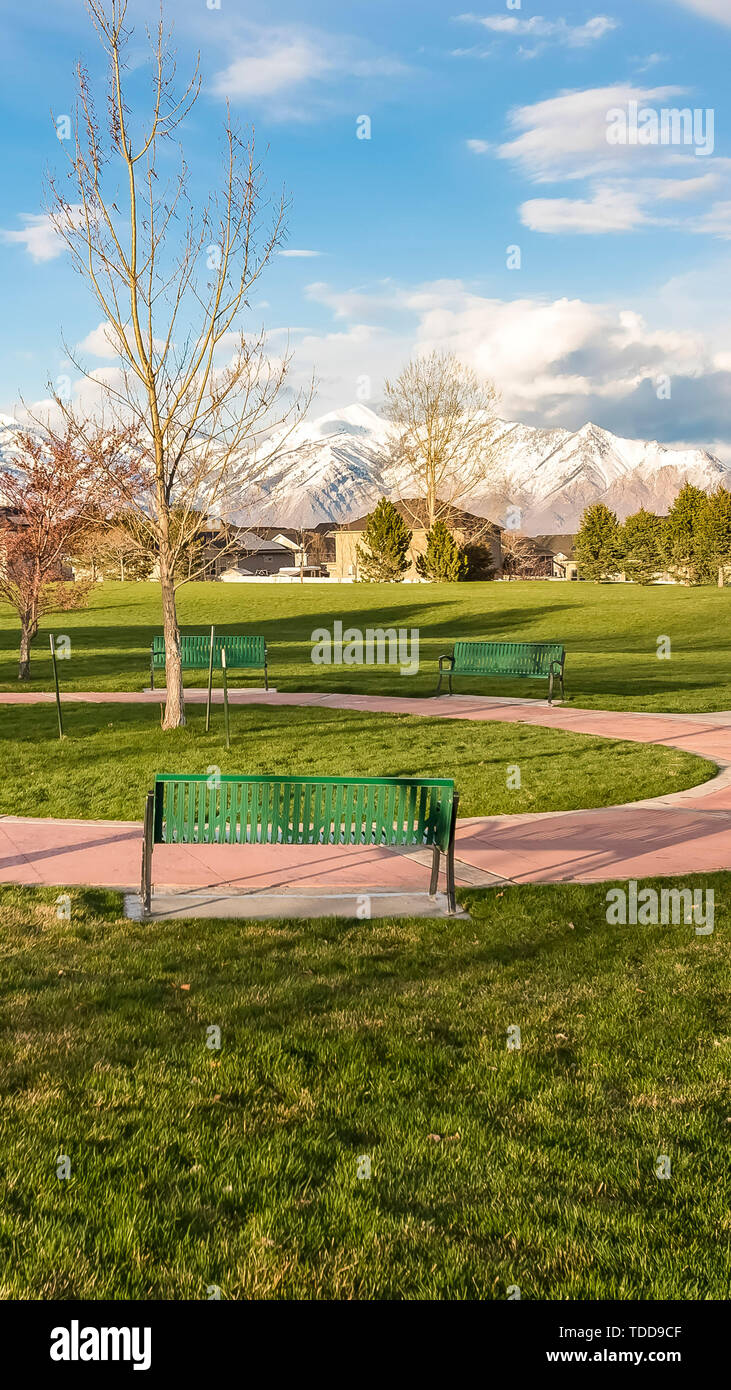 Vertical Green Benches Around A Circular Pathway On A Park With