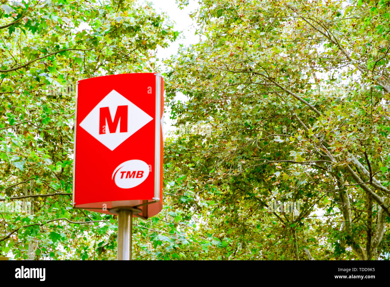 Barcelona, Spain - September 08, 2018: Trees and subway sign in the Rambla in summer in Barcelona, Spain Stock Photo