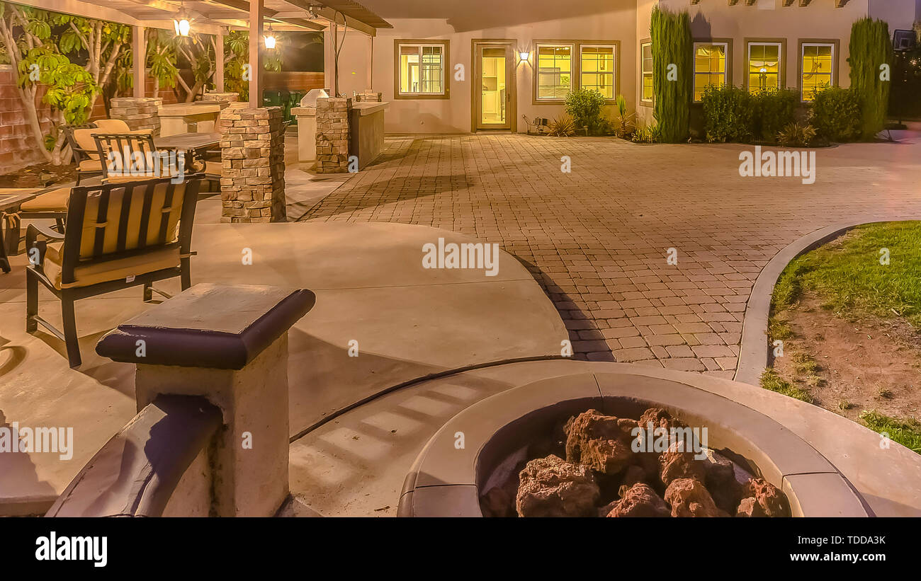 Panorama Frame Illuminated House With A Patio Accomodating An
