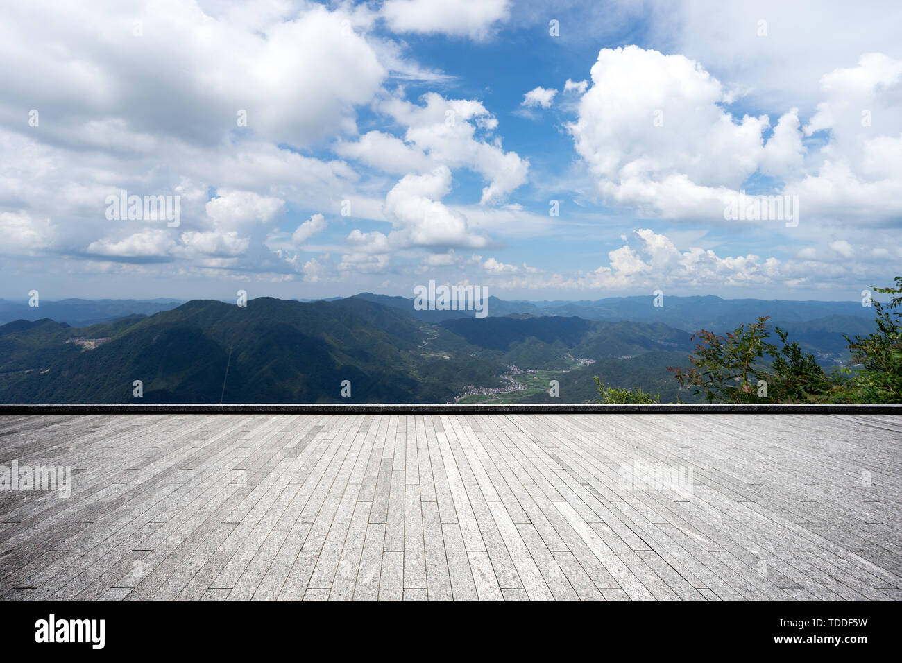 Empty brick floor with green hills Stock Photo