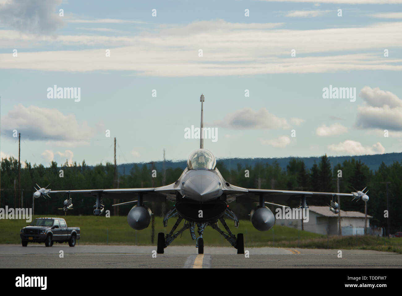 A U.S. Air Force F-16 Fighting Falcon assigned to the 18th Aggressor Squadron (AGRS), taxis toward the flightline during RED FLAG-Alaska 19-2 at Eielson Air Force Base, Alaska, June 10, 2019. The 18th AGRS replicates enemy tactics to give new pilots from visiting units the experience and training of simulated combat. (U.S. Air Force photo by Airman 1st Class Aaron Larue Guerrisky) Stock Photo