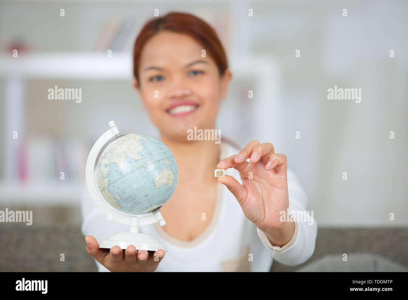 Woman holding globe telephone hi-res stock photography and images - Alamy