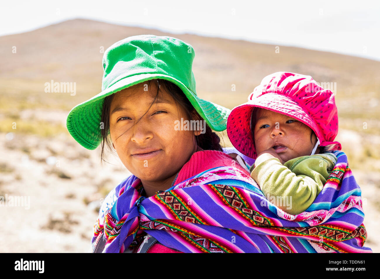Portrait of a Quechua woman with a baby in the Reserva Nacional de Salinas y Aguada Blanca, Arequipa, Peru, Stock Photo
