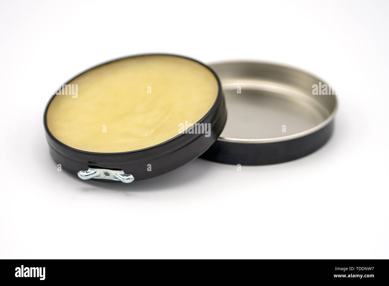 Colorless transparent wax for shoes. Open round container on a white ...