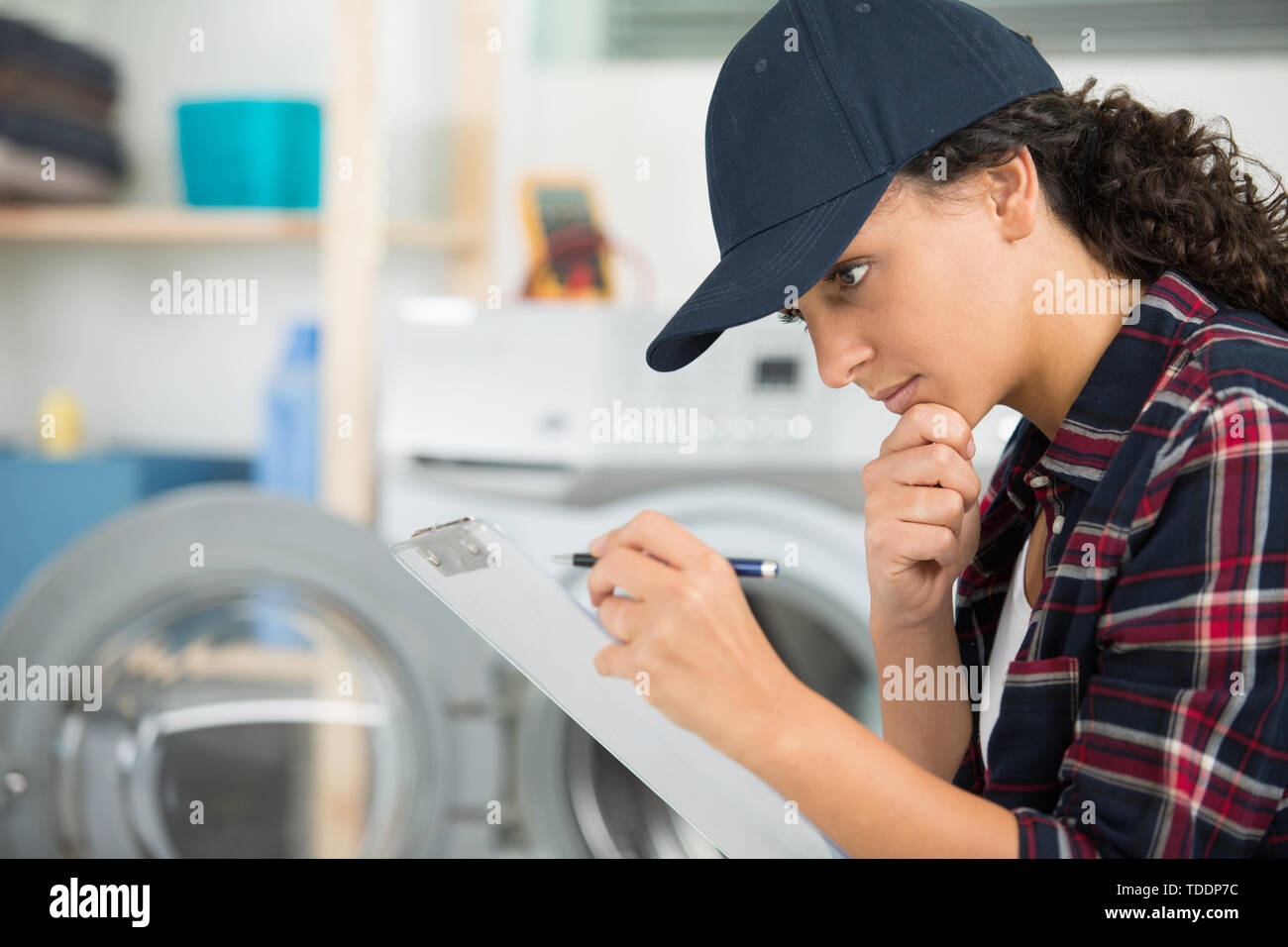female plumber working on central heating boiler Stock Photo