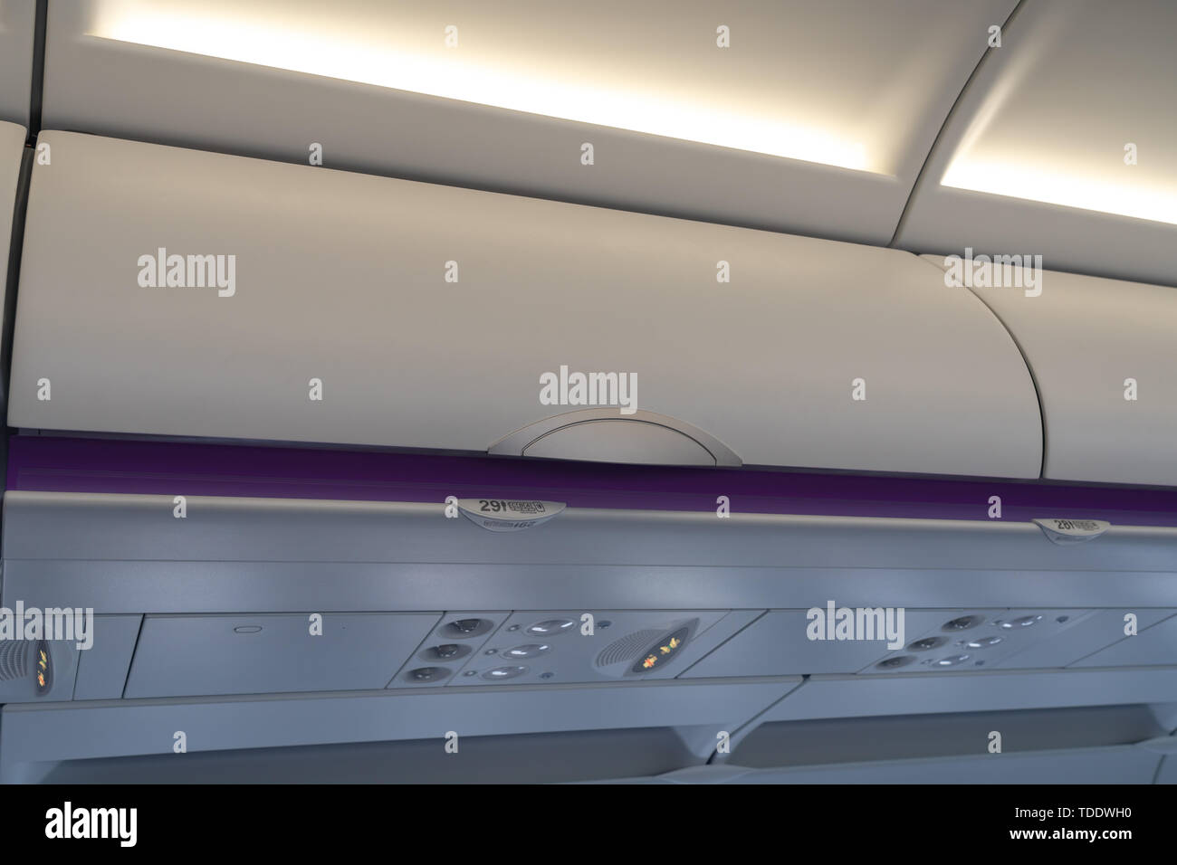 Carryon luggage in overhead storage compartment on commercial airplane