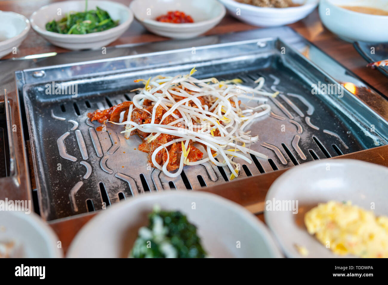 Grilled marinated pork kimchi topped with bean sprout eaten with