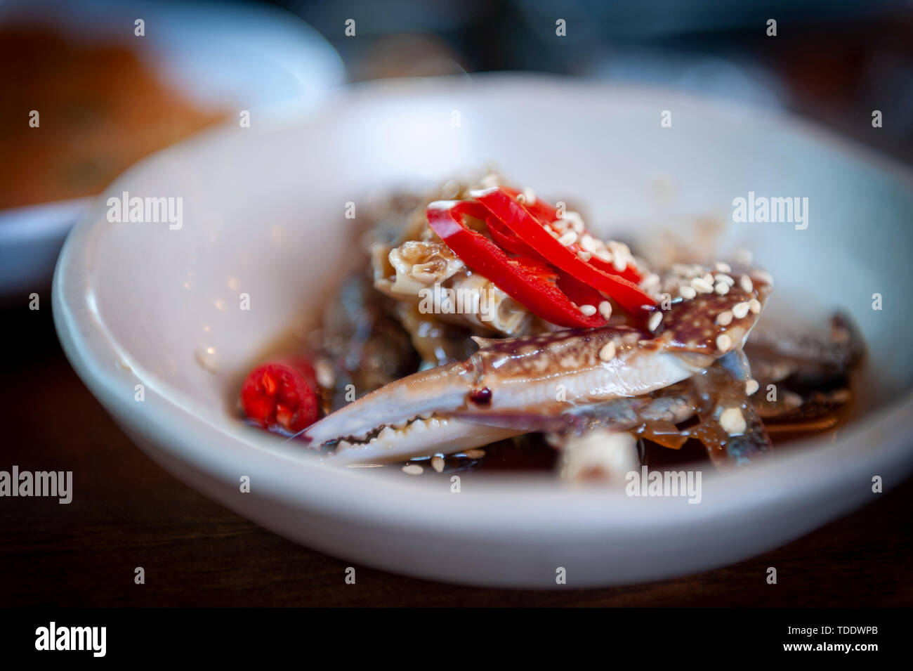 Marinated crab topped with fresh sliced chilli, a side dish to main course of Korean traditional