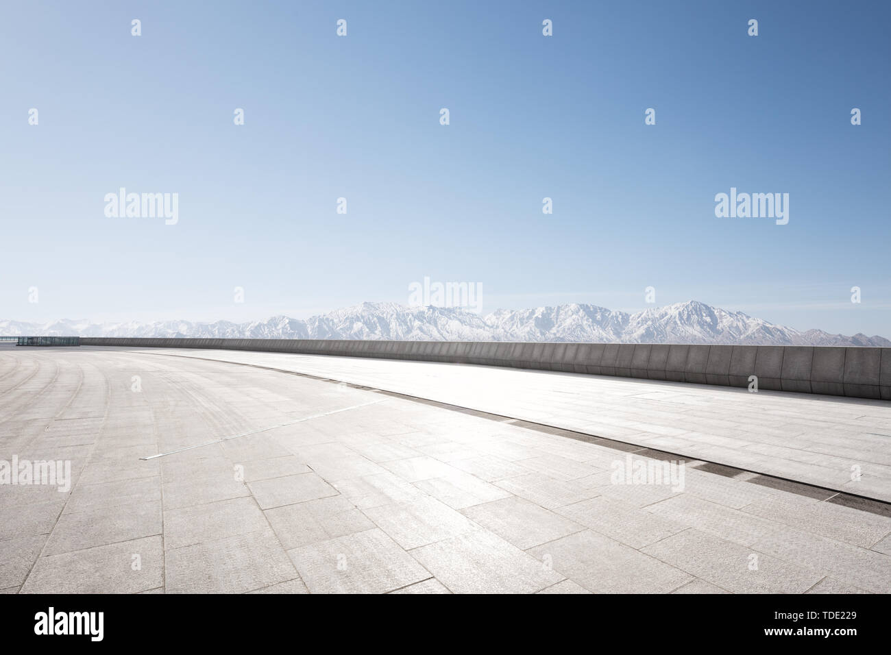 Empty floor with white snow mountains Stock Photo