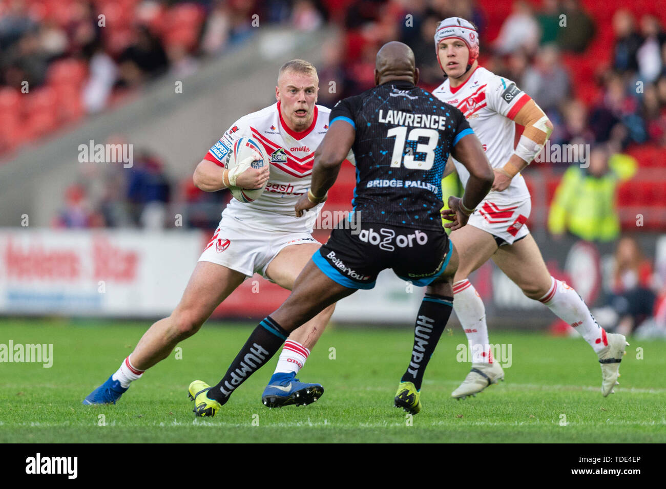14h June 2019 , Totally Wicked Stadium, St Helens, England;  Betfred Super League, Round 18, St Helens vs Huddersfield Giants, Jack Ashworth of St Helens looks for a way past Michael Lawrence (13) of Huddersfield Giants    Credit: Richard Long/News Images Stock Photo