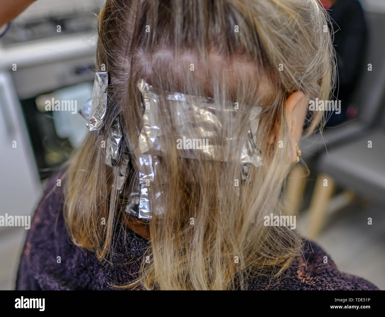 Close up shot of foil hair tinting process and shows foil parcels