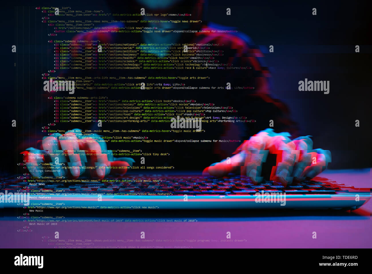 Hacker working with computer in dark room with digital interface around